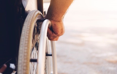 hand on wheelchair wheel